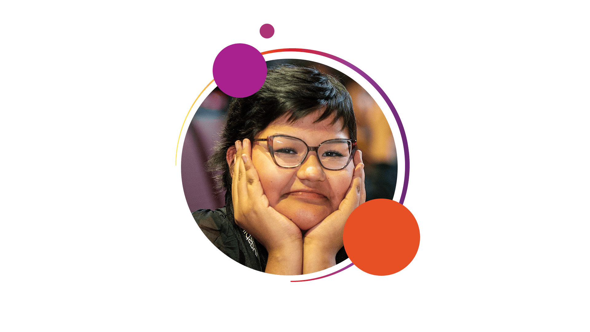 Person with short dark hair and glasses, smiling gently with their face resting in their hands. Framed by a circular border decorated with colorful circles in purple, orange, and pink.