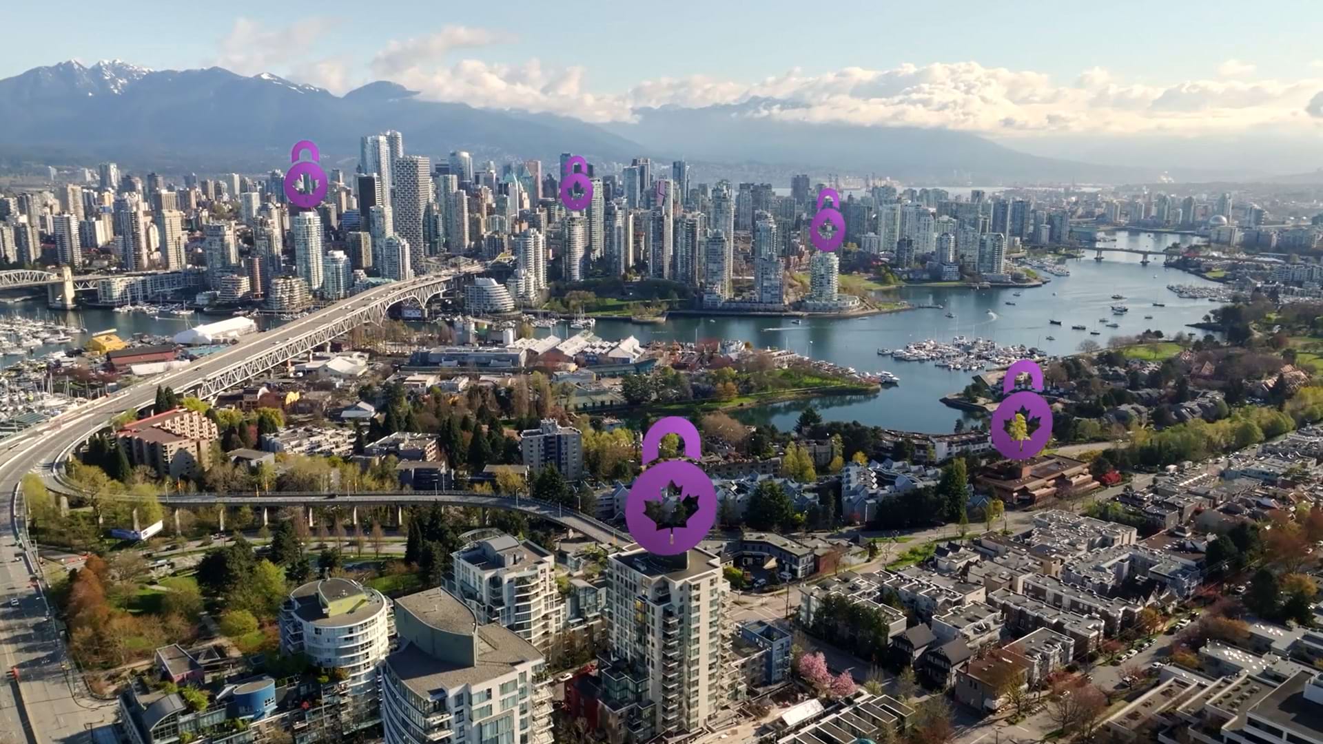 An aerial daytime view of a coastal city skyline surrounded by water and mountains in the distance. Several CDIC logos are superimposed, hovering over various buildings across the city.
