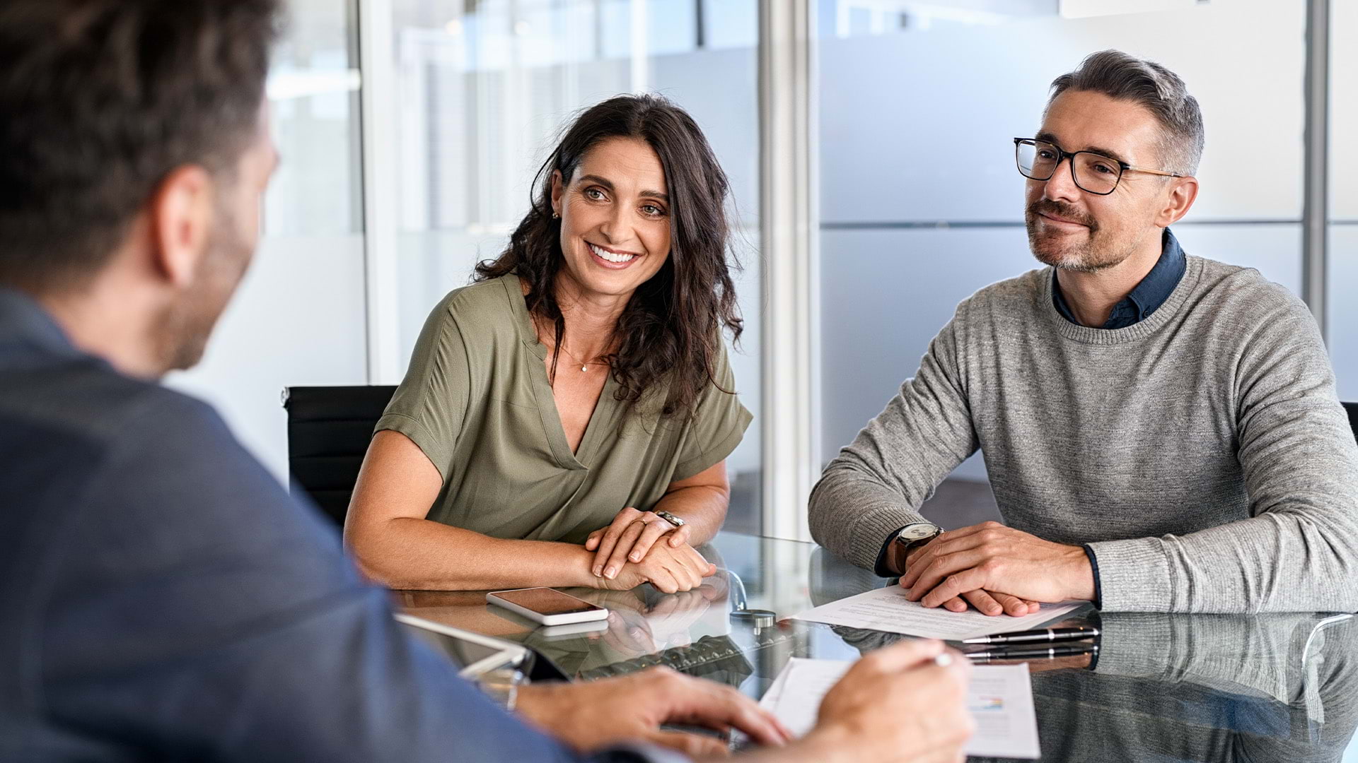 A couple meeting with a financial advisor at a member institution bank.
